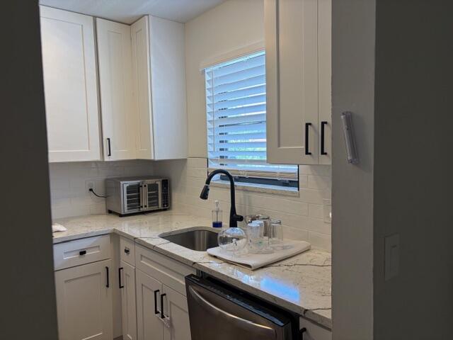 21906 Lake Forest Circle Boca Raton, FL 33433 - Photo 4 of 20 a kitchen with granite countertop a sink a stove and cabinets