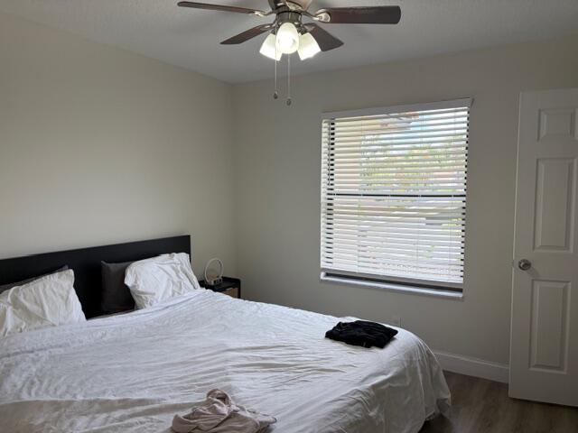 21906 Lake Forest Circle Boca Raton, FL 33433 - Photo 10 of 20 a bedroom with a bed and a window