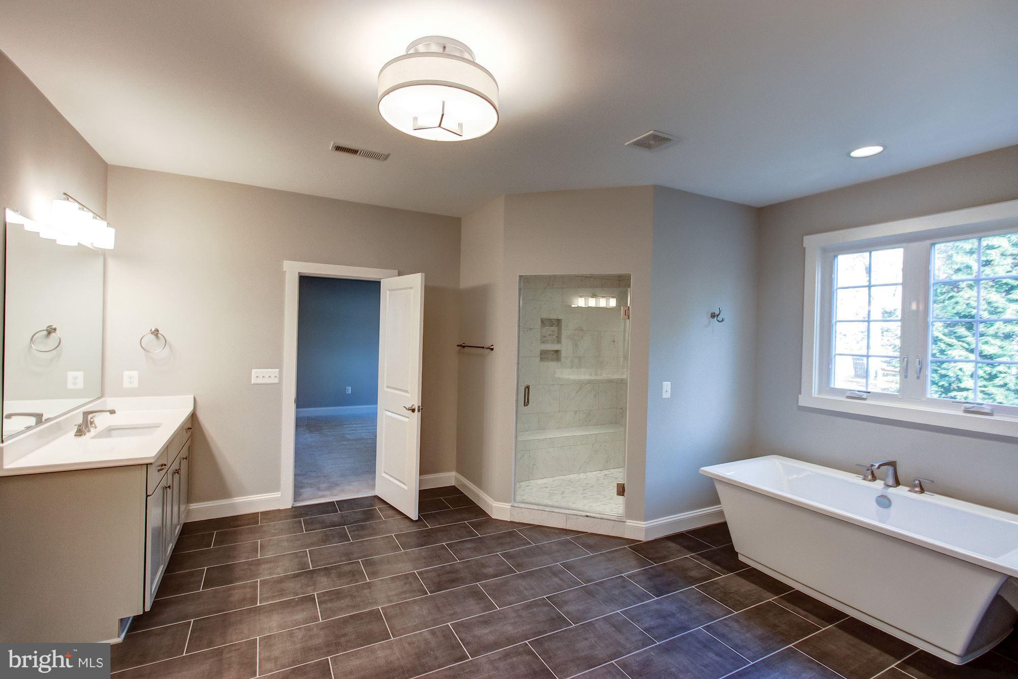 9420 Athens Road Fairfax, VA 22032 - Photo 13 of 19 a bathroom with a tub sink and mirror