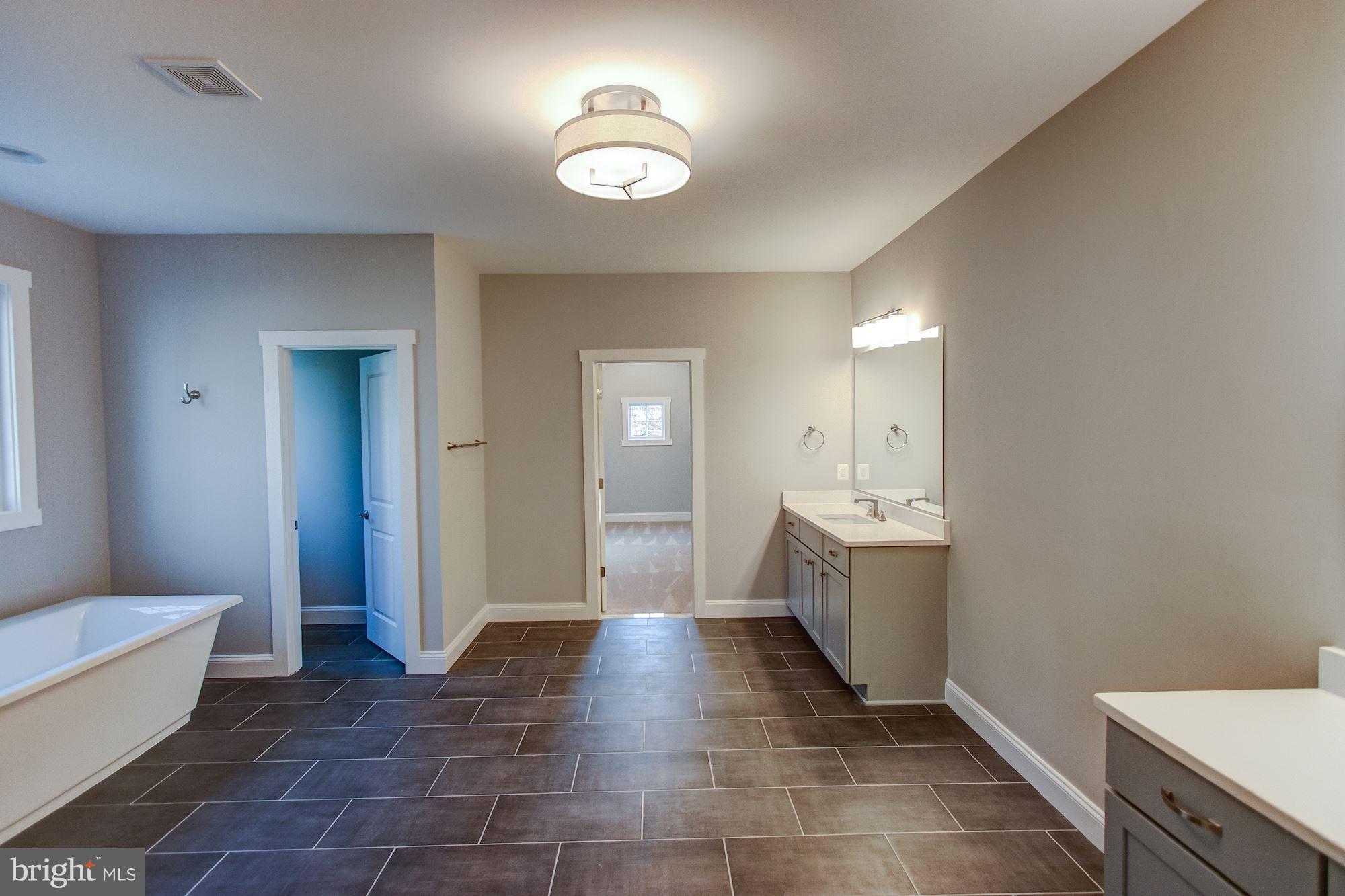 9420 Athens Road Fairfax, VA 22032 - Photo 14 of 19 a bathroom with a sink a toilet and mirror