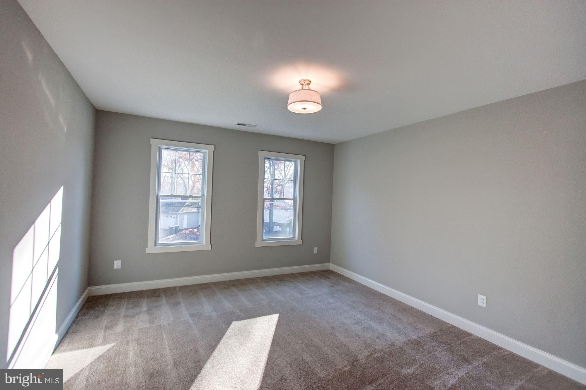 9420 Athens Road Fairfax, VA 22032 - Photo 17 of 19 an empty room with wooden floor and windows