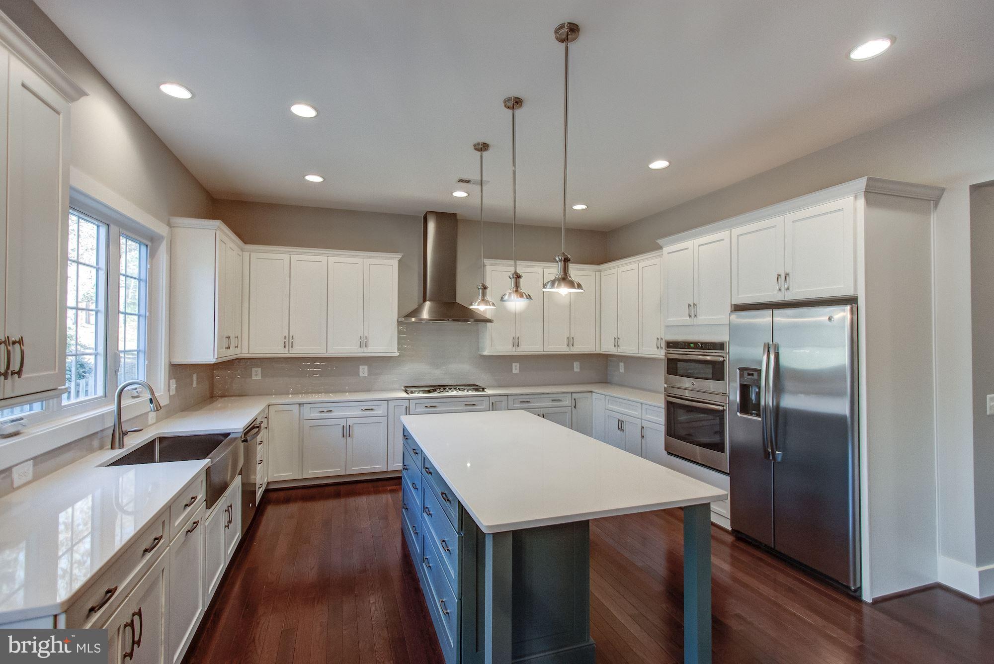 9420 Athens Road Fairfax, VA 22032 - Photo 6 of 19 a kitchen with a sink a counter space stainless steel appliances and windows