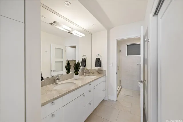 a bathroom with a double vanity sink and mirror