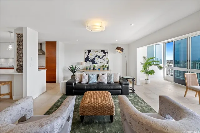 a living room with furniture and a potted plant