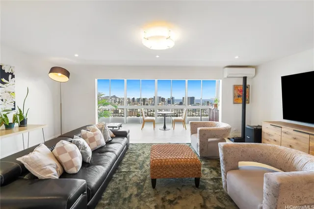 a living room with furniture kitchen view and a large window