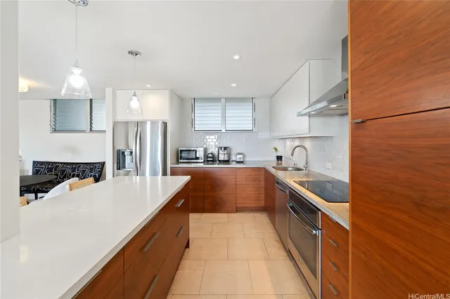 a large kitchen with stainless steel appliances granite countertop a sink and cabinets
