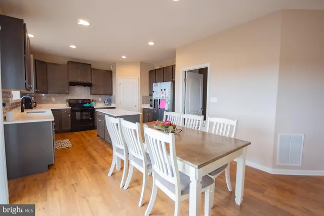 a kitchen with stainless steel appliances granite countertop a refrigerator and a sink