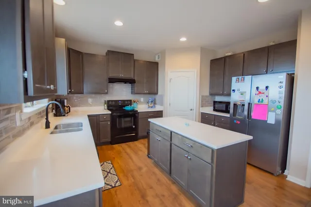 a spacious bathroom with a double vanity sink a mirror and a bathtub