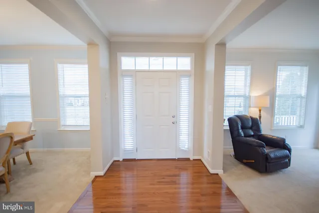 a view of a dining room with furniture and chandelier