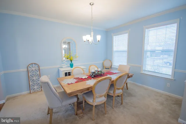 a view of a dining room with furniture and window