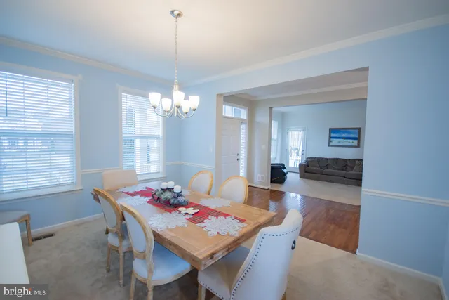 a view of a dining room with furniture and chandelier