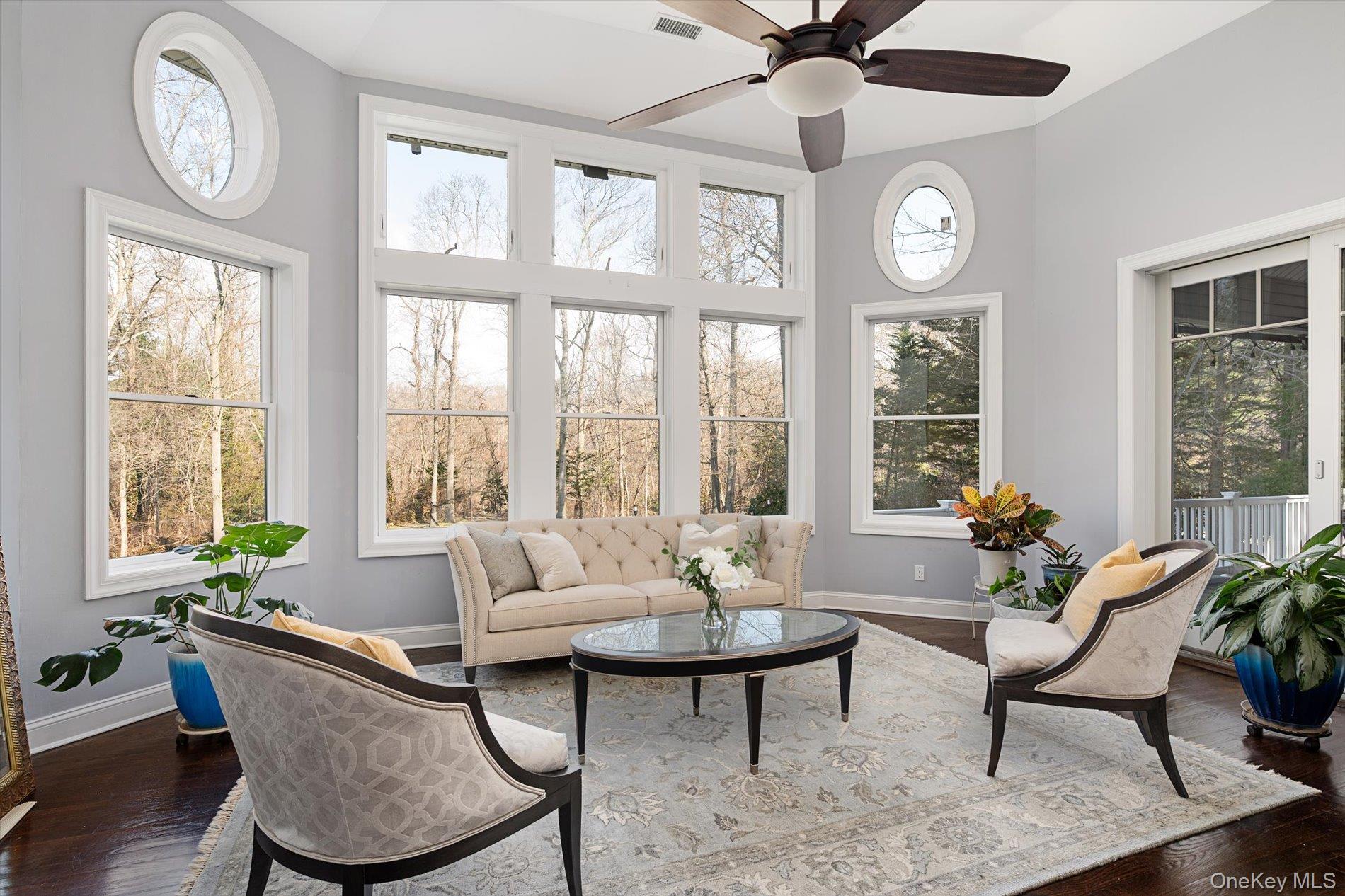 7 Riga Lane Melville, NY 11747 - Photo 11 of 33 a living room with furniture a window and a clock