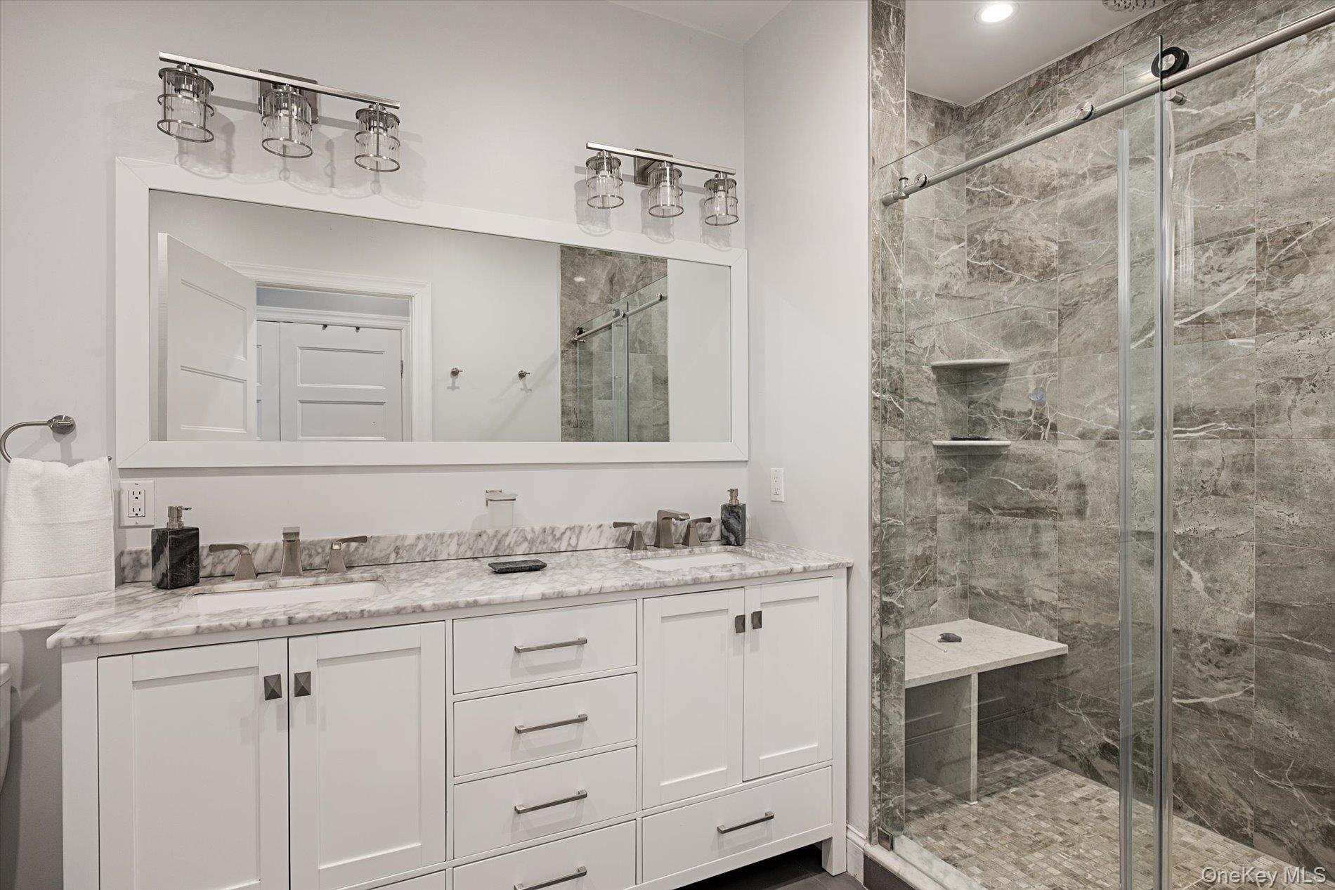 7 Riga Lane Melville, NY 11747 - Photo 15 of 33 a bathroom with a double vanity sink mirror and toilet