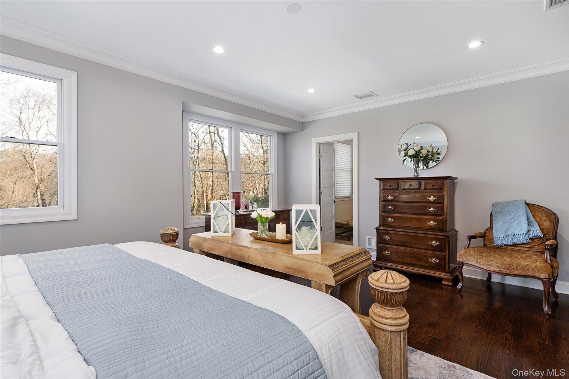 7 Riga Lane Melville, NY 11747 - Photo 18 of 33 a bedroom with a bed and wooden floor