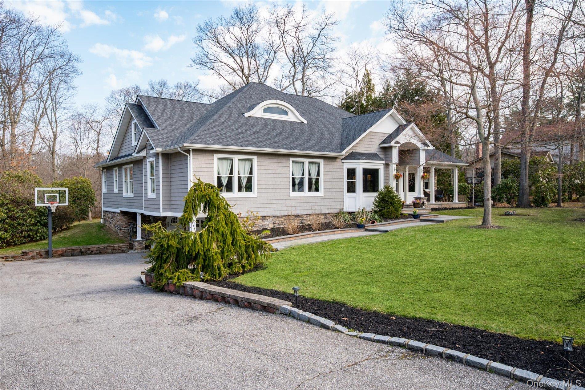 7 Riga Lane Melville, NY 11747 - Photo 2 of 33 front view of a house with a yard