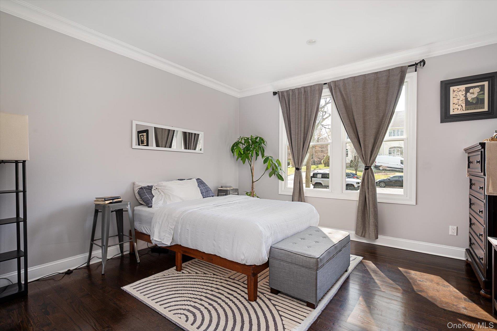 7 Riga Lane Melville, NY 11747 - Photo 24 of 33 a bedroom with a bed and wooden floor