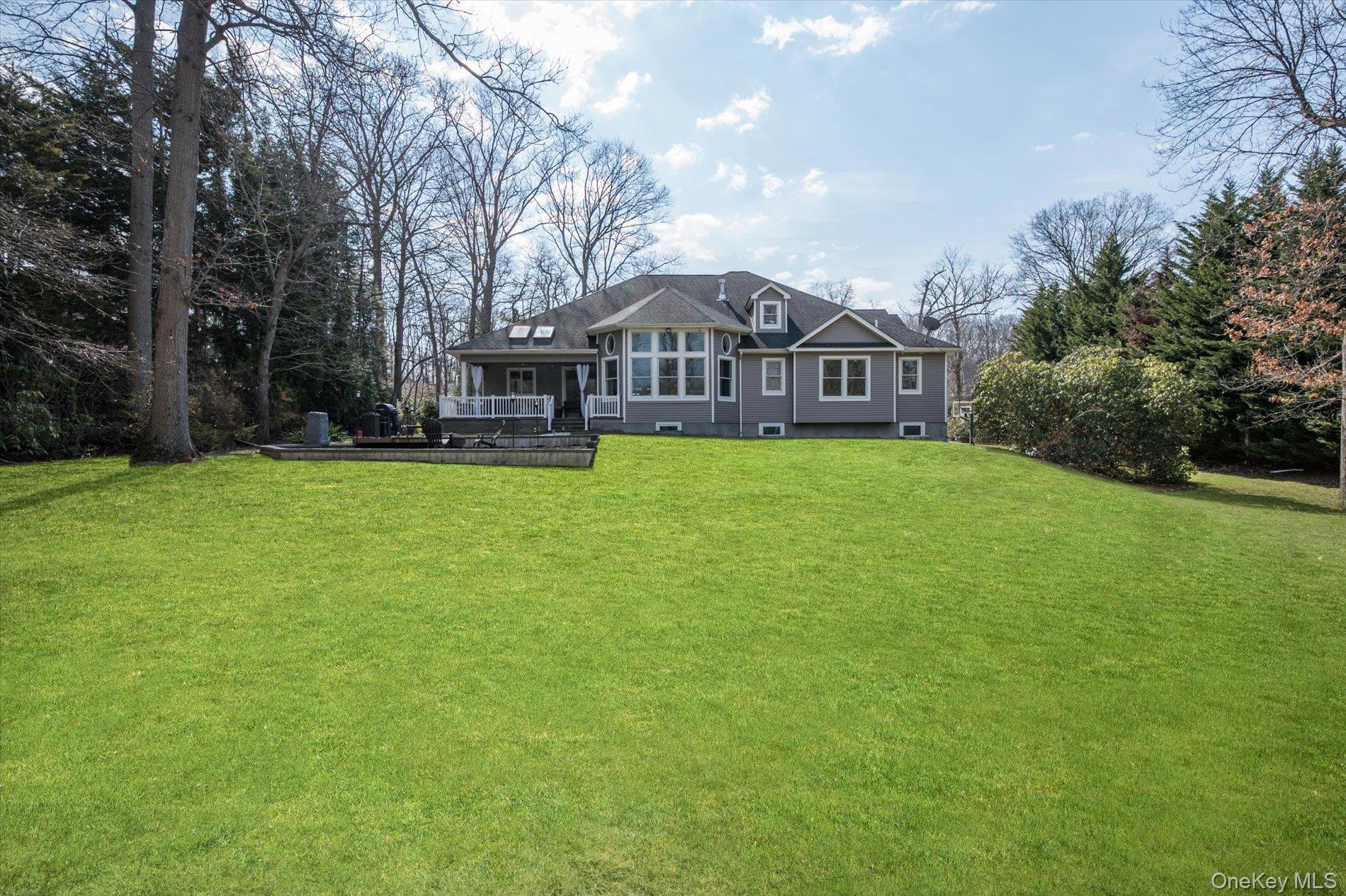 7 Riga Lane Melville, NY 11747 - Photo 30 of 33 a front view of a house with yard and green space