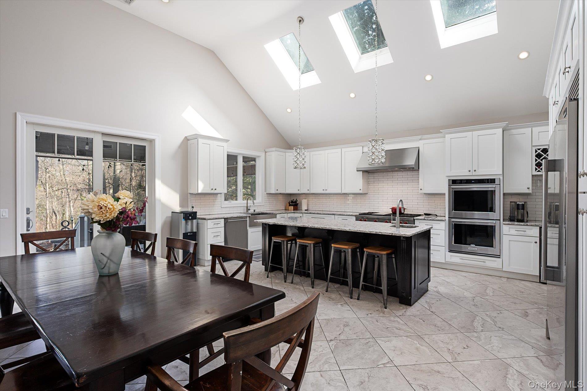 7 Riga Lane Melville, NY 11747 - Photo 4 of 33 a large kitchen with a table and chairs