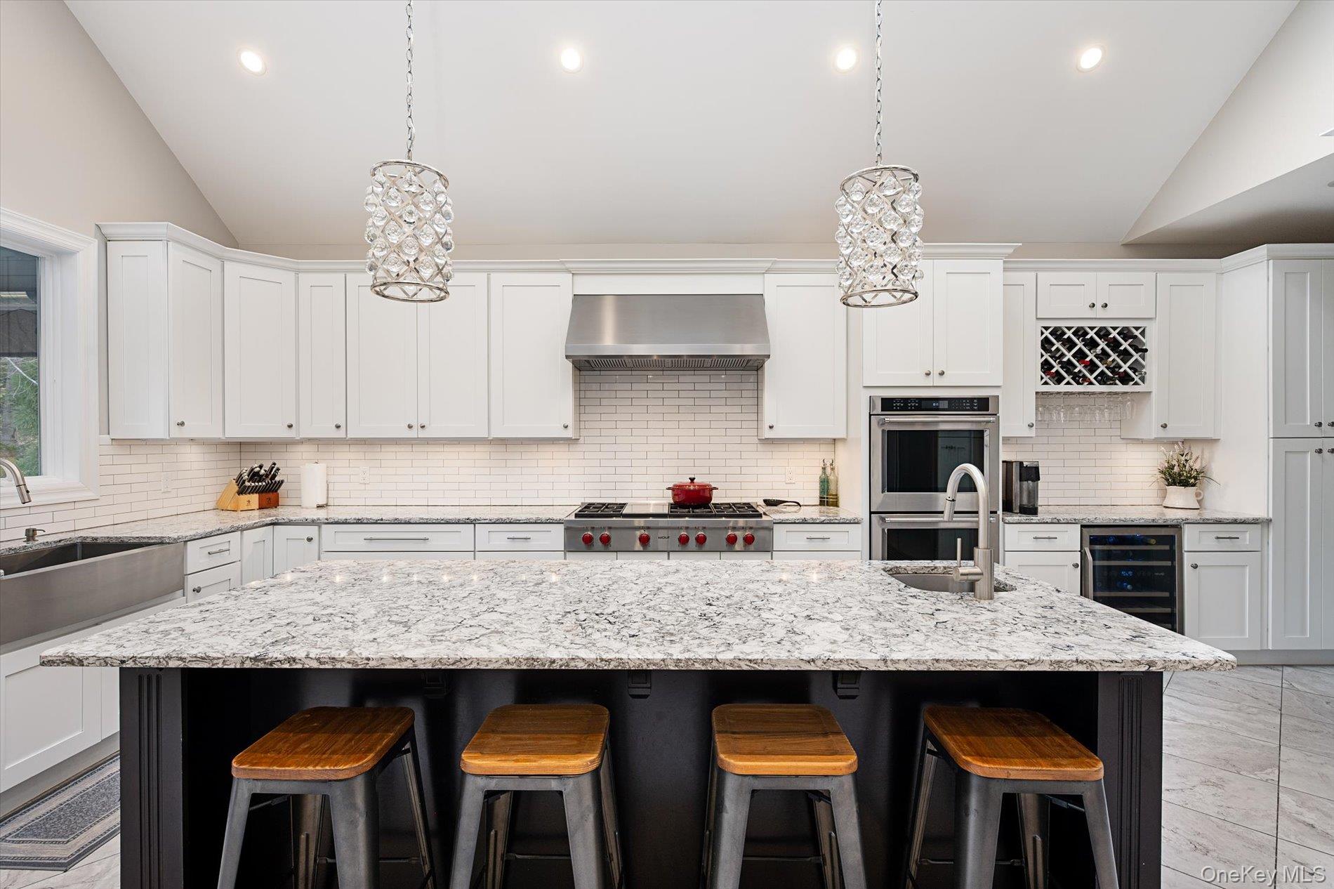 7 Riga Lane Melville, NY 11747 - Photo 5 of 33 a kitchen with stainless steel appliances granite countertop a stove a sink a refrigerator and chairs