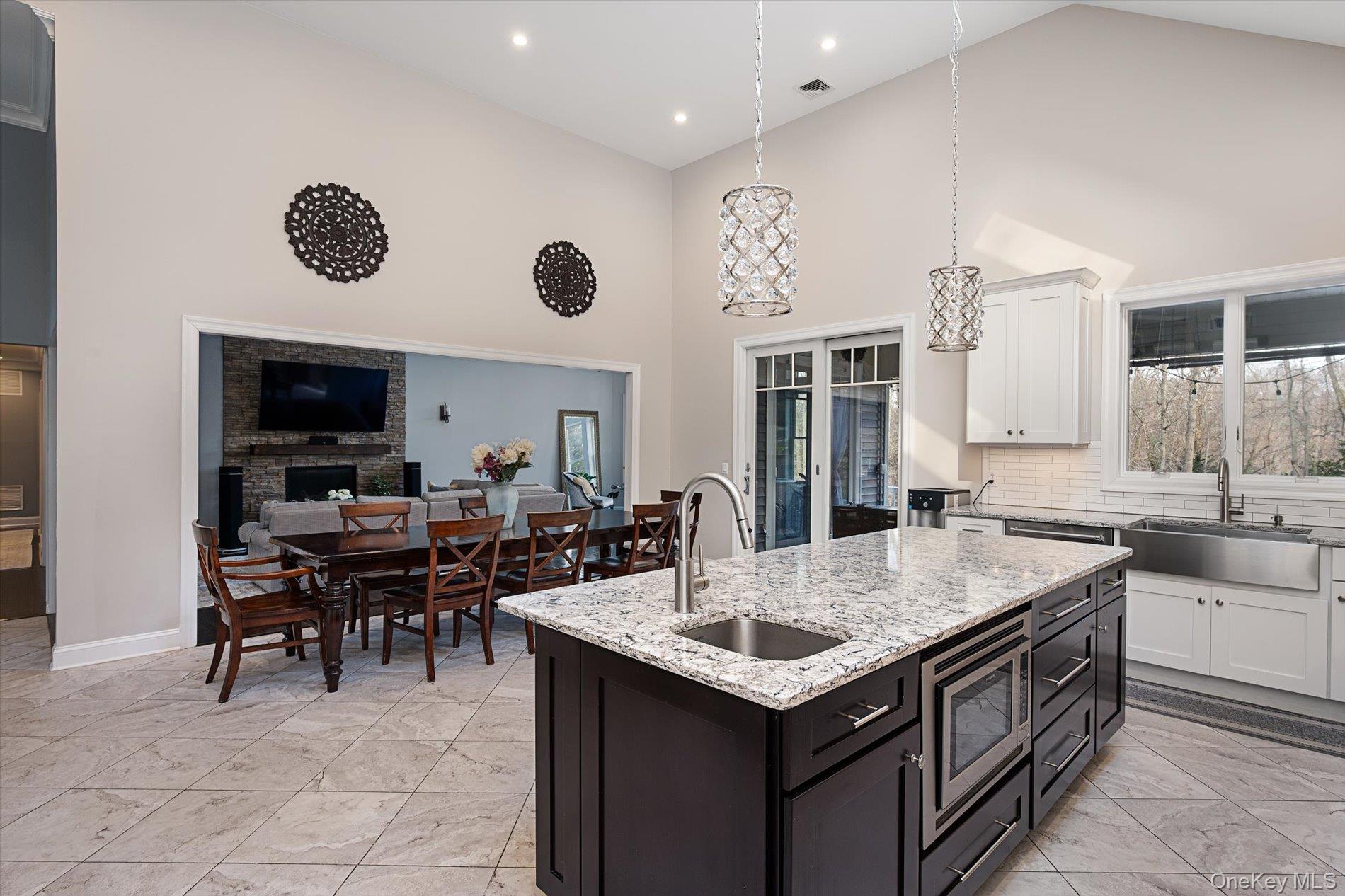 7 Riga Lane Melville, NY 11747 - Photo 6 of 33 a open kitchen with a table and chairs in it