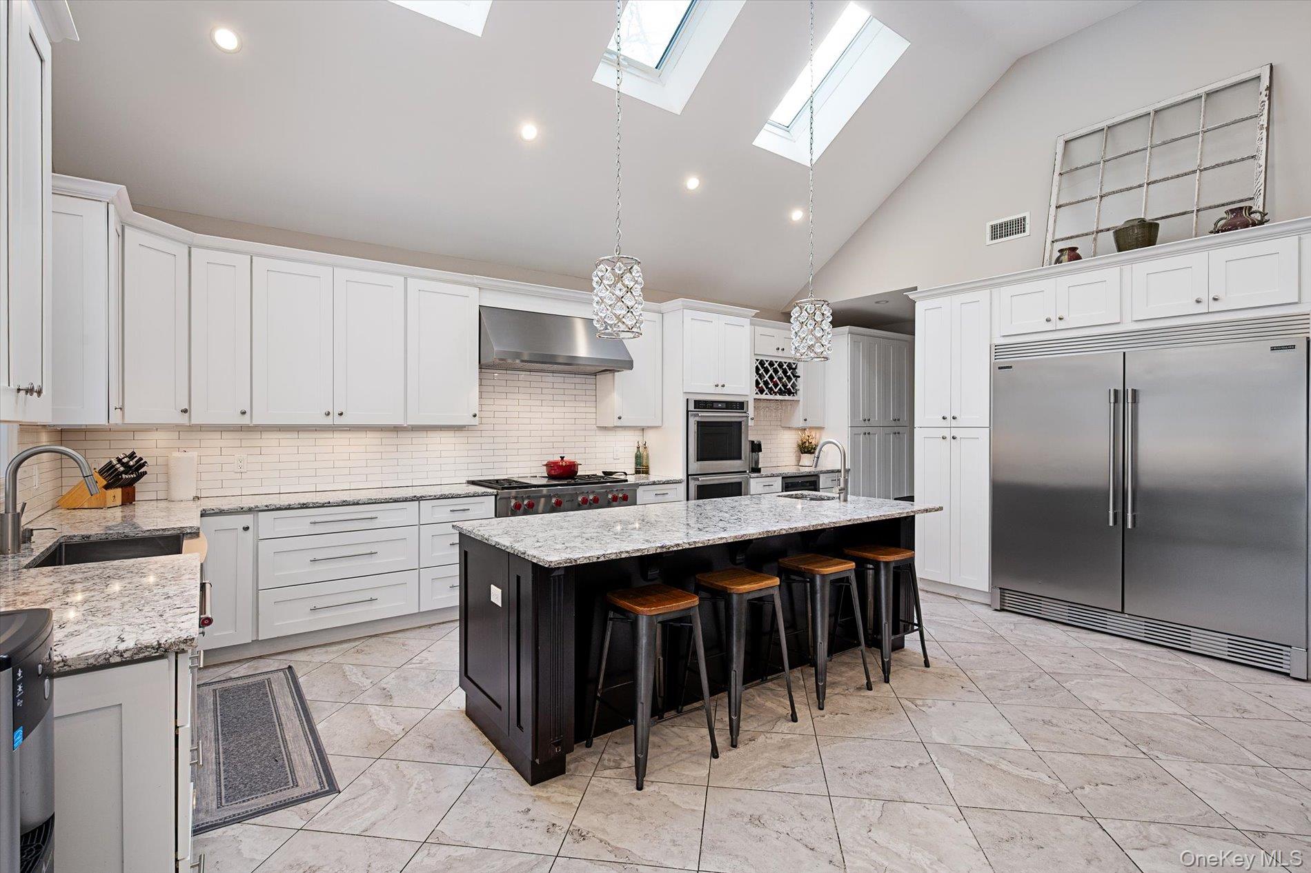 7 Riga Lane Melville, NY 11747 - Photo 7 of 33 a kitchen with kitchen island granite countertop a sink counter top space appliances and cabinets