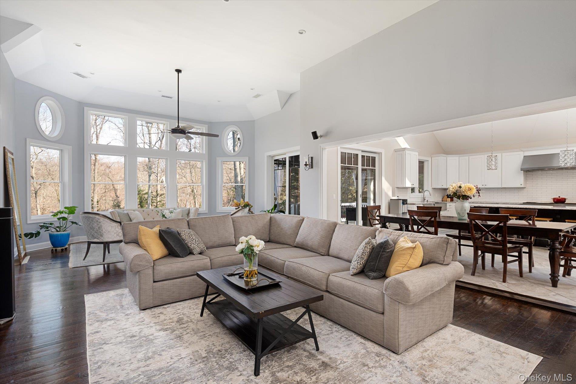 7 Riga Lane Melville, NY 11747 - Photo 10 of 33 a living room with furniture kitchen view and a chandelier