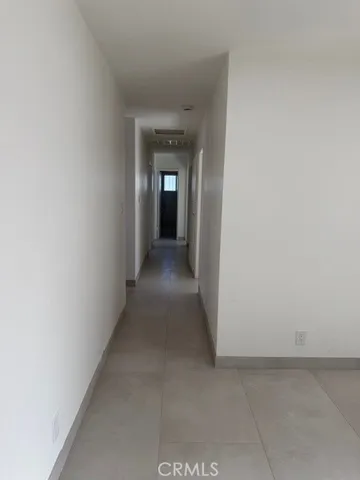 a view of a hallway to an empty room