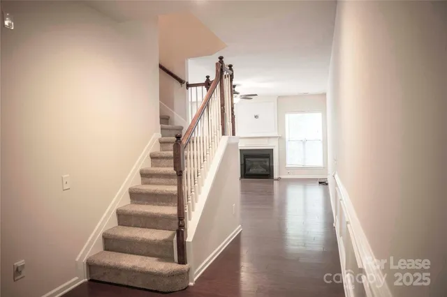 a view of entryway and hall with wooden floor