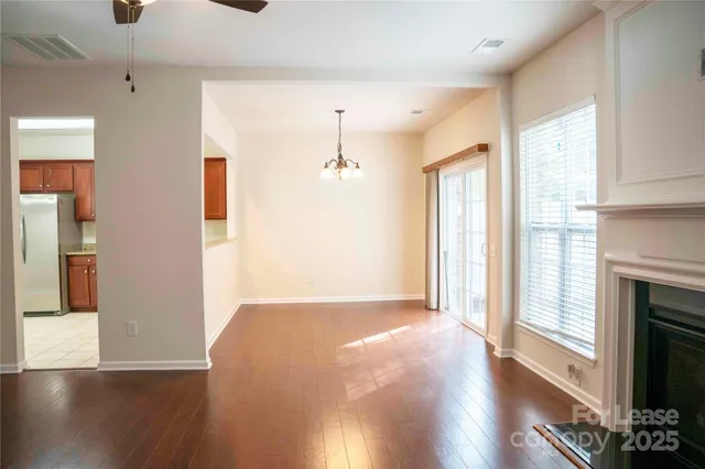 a view of a room with wooden floor and a fireplace