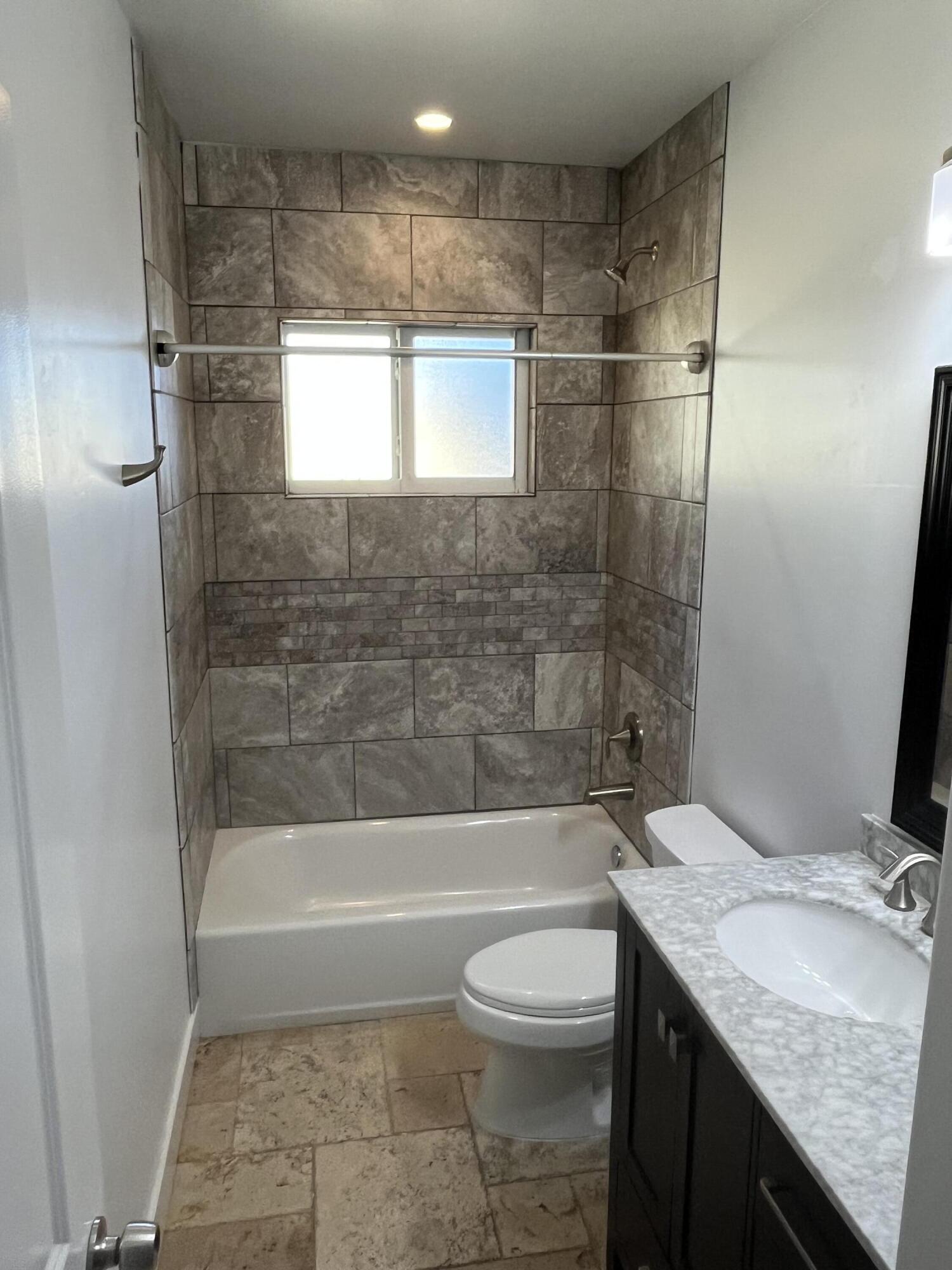 639 Cabrera Street Key Largo, FL 33037 - Photo 22 of 24 a bathroom with a granite countertop sink toilet and shower