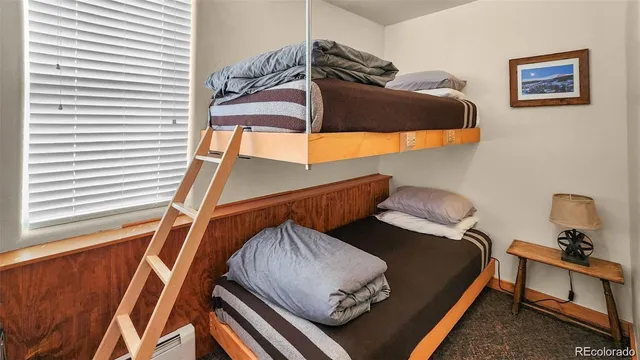 a bedroom with a bed and cabinets