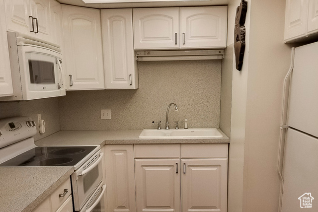 2855 South 1000 West Perry, UT 84302 - Photo 20 of 142 Kitchen featuring white appliances, light countertops, and white cabinets