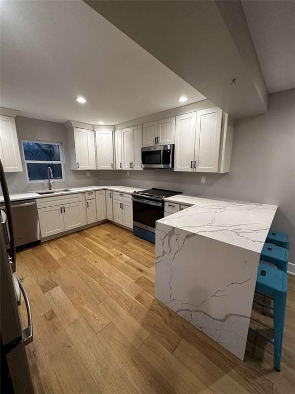 5131 Keiners Lane Pittsburgh, PA 15205 - Photo 20 of 24 a large kitchen with stainless steel appliances kitchen island granite countertop a stove a sink a microwave and a refrigerator