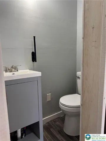 a bathroom with a sink toilet and a mirror