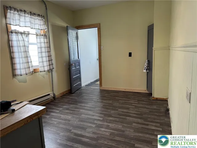a view of a room with wooden floor and windows