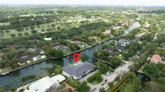 an aerial view of residential houses with outdoor space and lake view