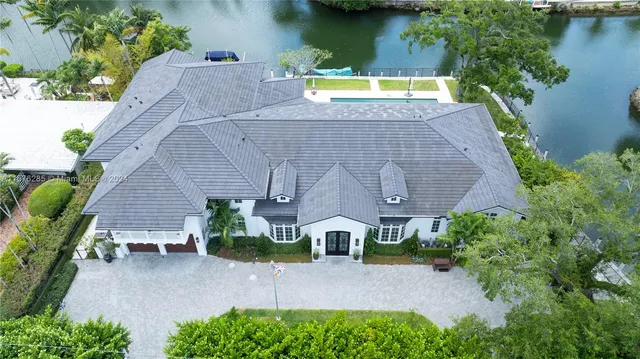 an aerial view of a house with garden space and a patio