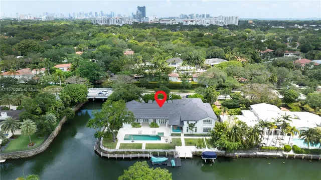 an aerial view of house with yard swimming pool and outdoor seating