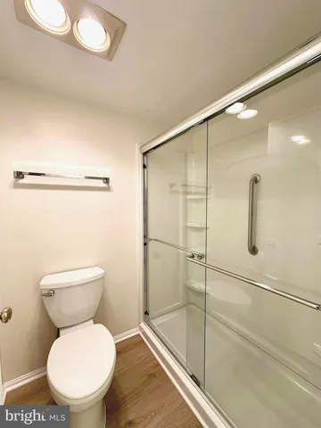 a bathroom with a toilet and a shower