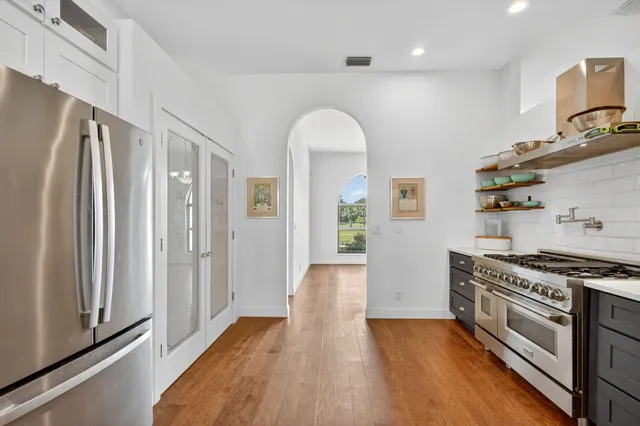 a bathroom with a granite countertop sink a toilet and a mirror