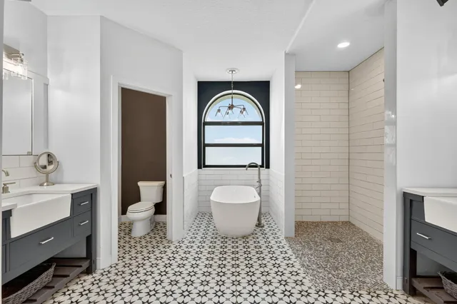 an aerial view of residential houses with outdoor space and trees all around