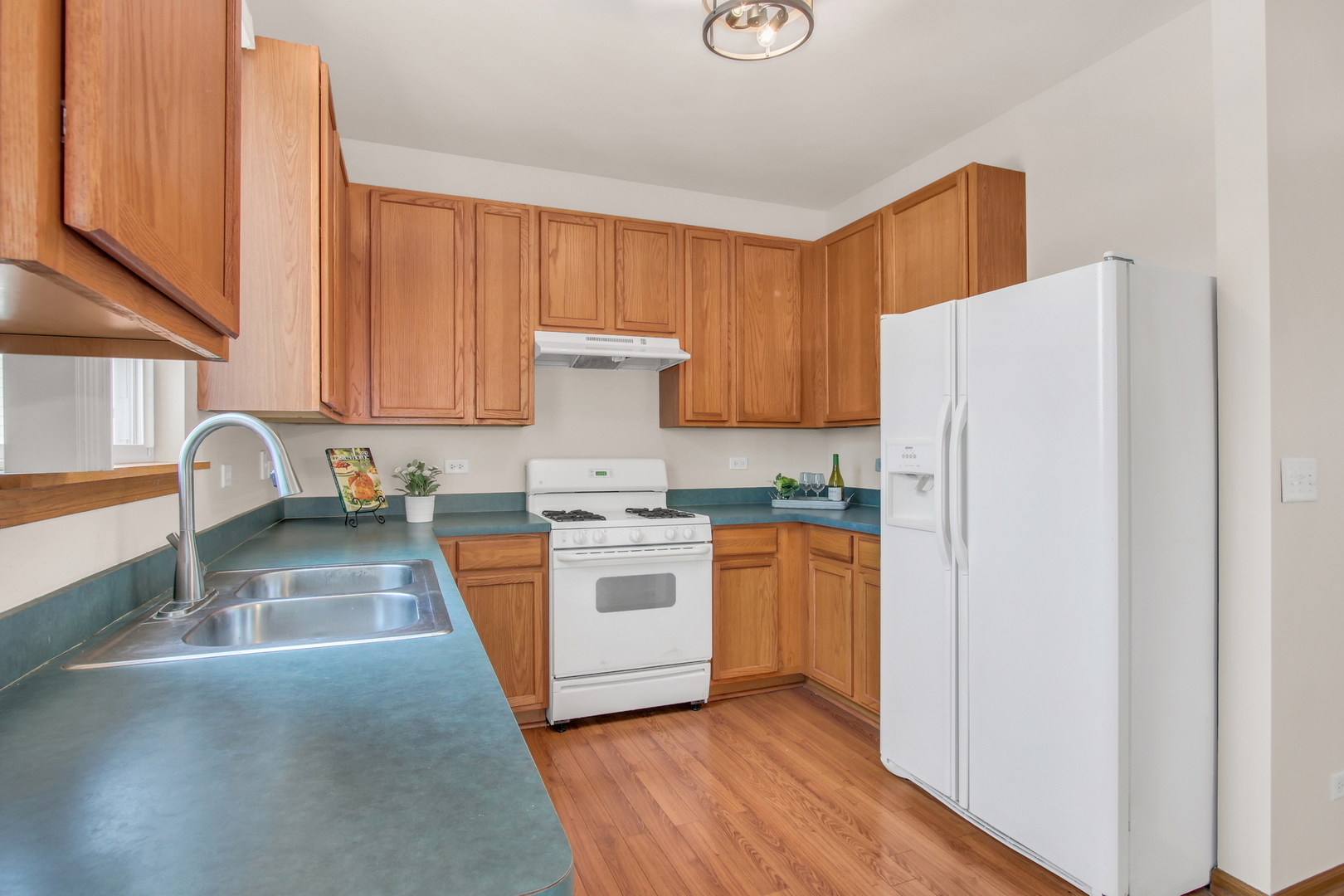 1014 Devon Drive Antioch, IL 60002 - Photo 28 of 51 a kitchen with stainless steel appliances granite countertop a refrigerator a stove top oven a sink and dishwasher with wooden floor