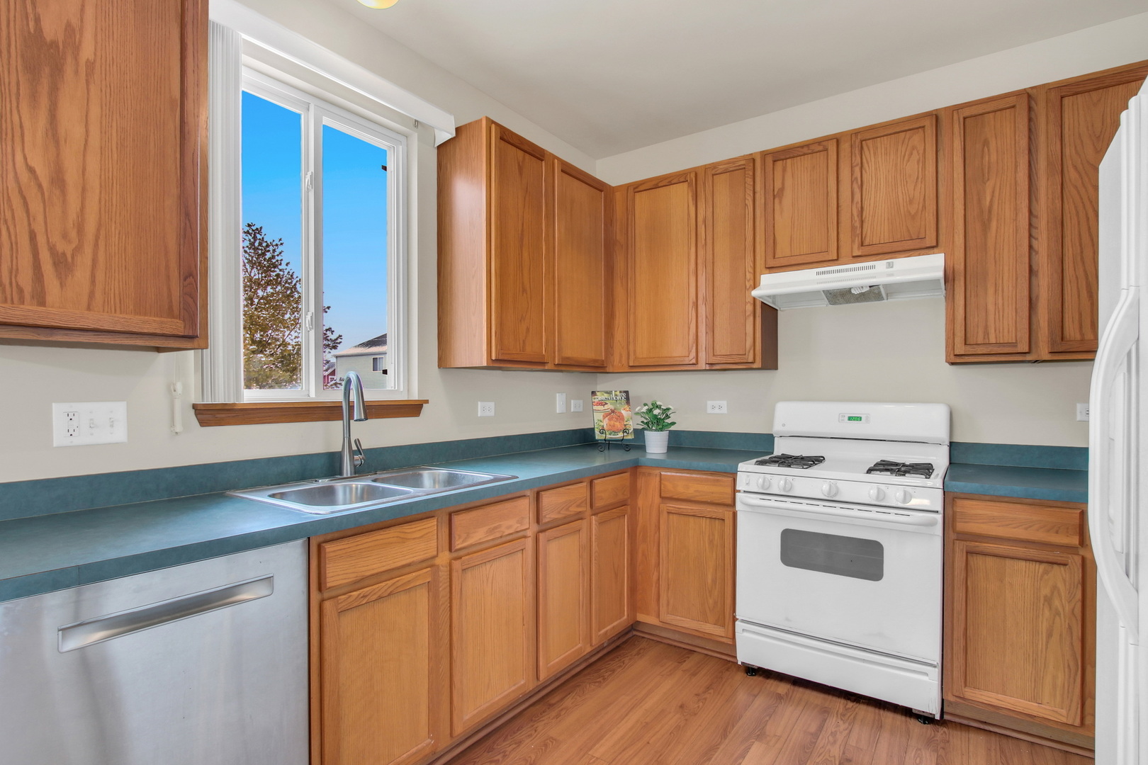 1014 Devon Drive Antioch, IL 60002 - Photo 29 of 51 a kitchen with granite countertop stainless steel appliances white cabinets granite counter tops and a wooden floors