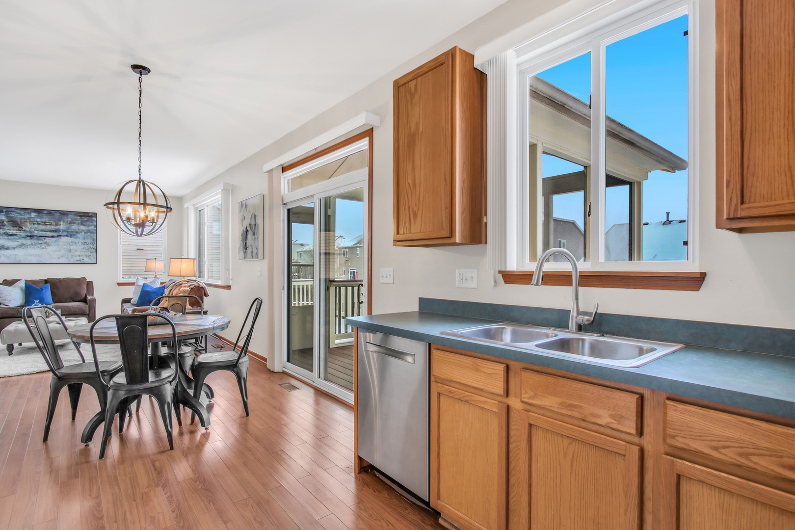 1014 Devon Drive Antioch, IL 60002 - Photo 30 of 51 a kitchen with stainless steel appliances granite countertop wooden floor a dining table and chairs