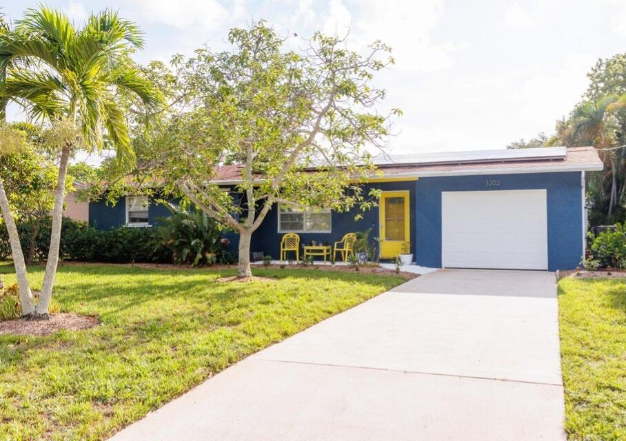 1202 East Madison Avenue Stuart, FL 34996 - Photo 1 of 23 a front view of house with yard