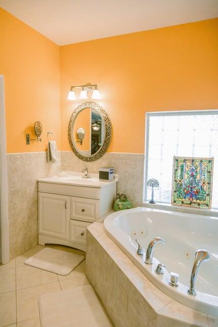 1202 East Madison Avenue Stuart, FL 34996 - Photo 11 of 23 a bathroom with a tub sink and mirror
