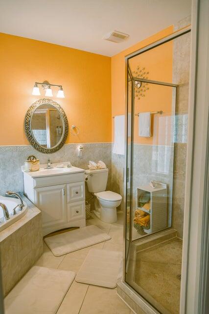 1202 East Madison Avenue Stuart, FL 34996 - Photo 12 of 23 a bathroom with a toilet a sink and shower