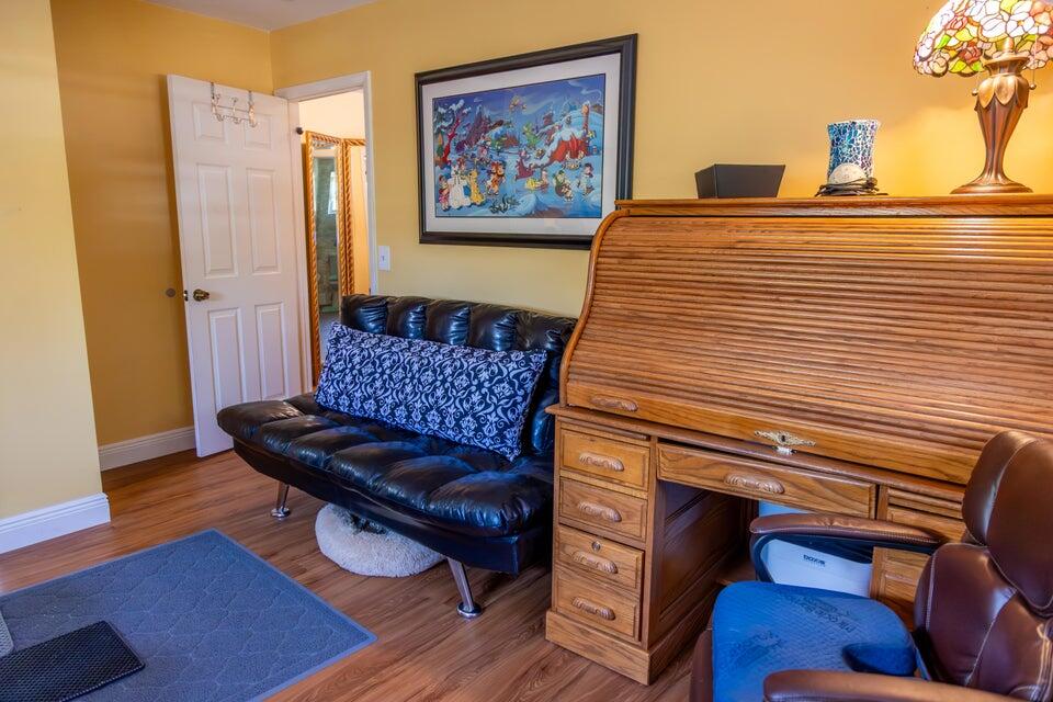 1202 East Madison Avenue Stuart, FL 34996 - Photo 14 of 23 a bedroom with a bed and wooden floor
