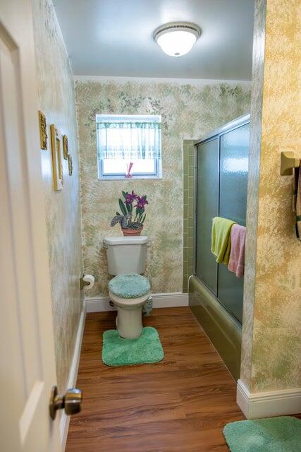 1202 East Madison Avenue Stuart, FL 34996 - Photo 15 of 23 a view of a hallway with wooden floor and a potted plant