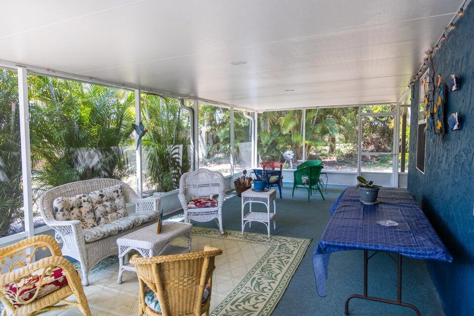 1202 East Madison Avenue Stuart, FL 34996 - Photo 17 of 23 a living room with furniture and a floor to ceiling window